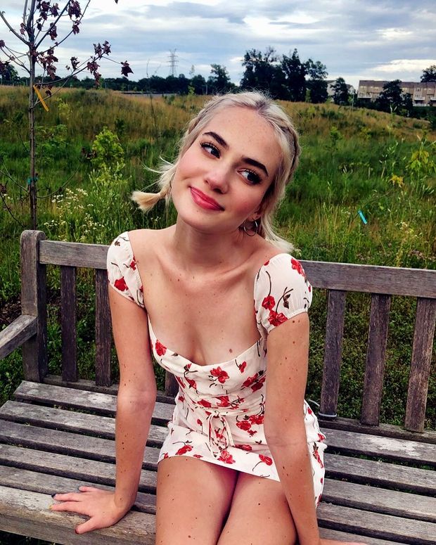 Cute blond Babe on park bench in a minidress