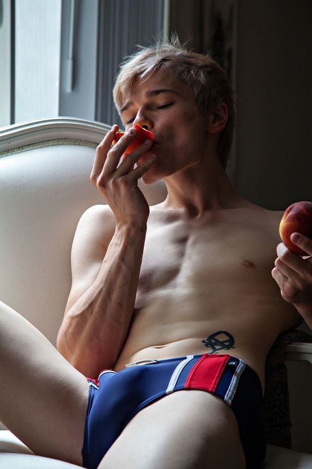Teen eating a peach.