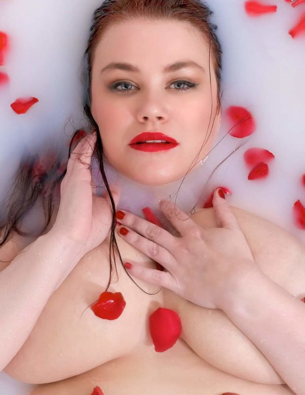 Ruby Roxx with rose peddles in a milk path