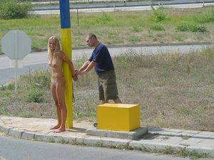 tied to pole, stripped and left exposed