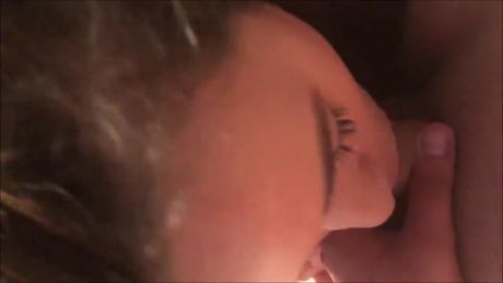 Sexy teen with big tits getting on her knees and pleasing two men at the same time.