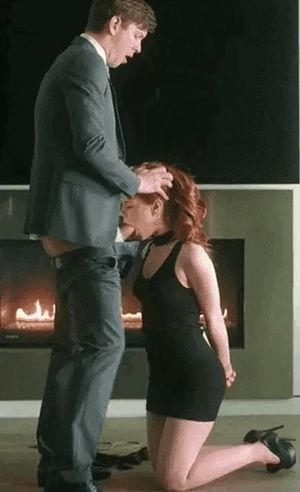 redhead sucks in front of a fire
