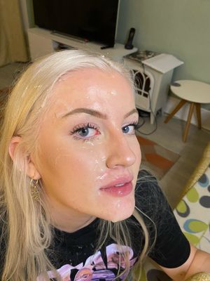 Sexy blonde whore enjoys her first facial.