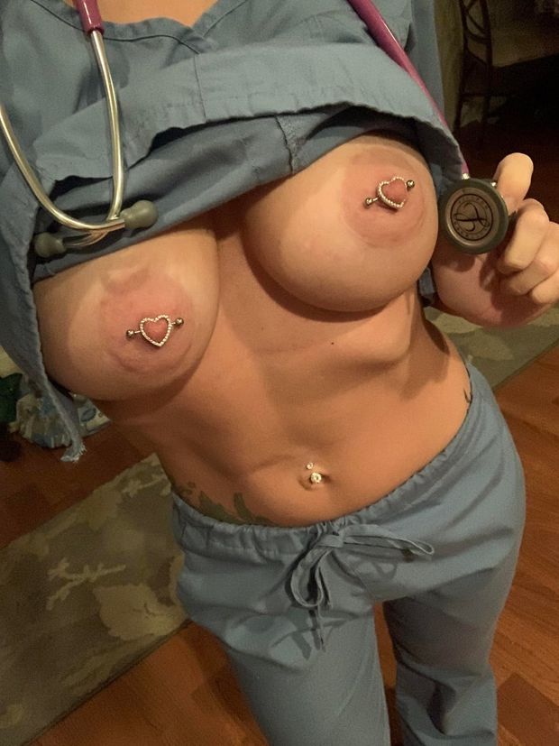 Nurse showing off her pierced nipples