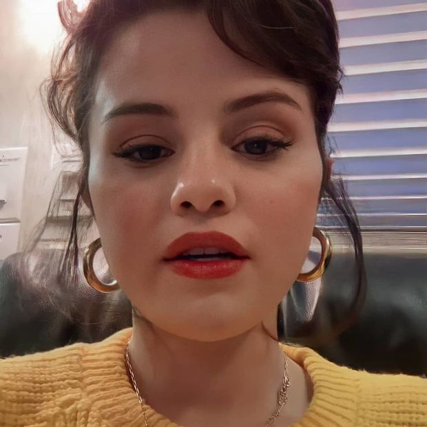 Selena in lipstick with her hair up