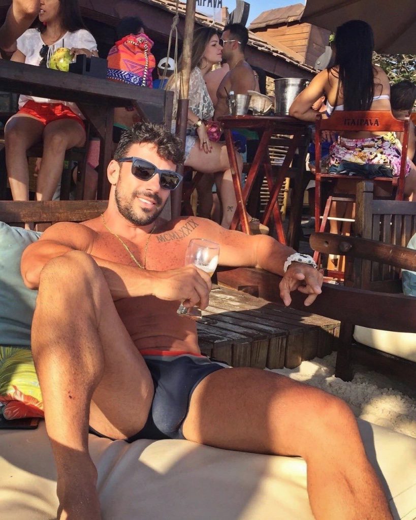 Handsome hunk with an enormous speedo bulge enjoying a frosty cold beer.  This manspreading speedo hunk has me thinking