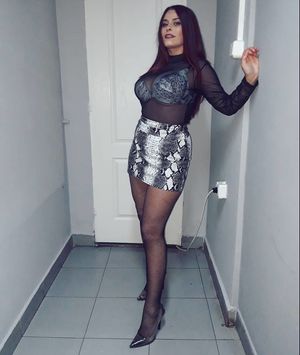 Busy babe in mini skirt and sheer blouse