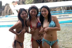 Sexy asians flashing tits near water