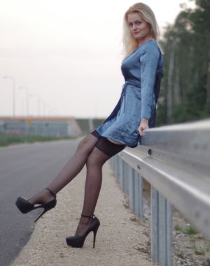 Hot nasty blonde posing outdoors in blue silk robe black stockings and really high heeled sandlas