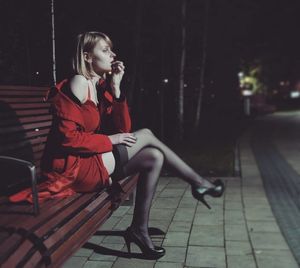 Nasty blonde teasing guys in park in red mini dress stockings and high heeled pumps