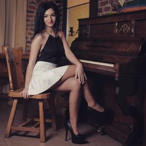 Cute brunette in mini skirt and heels