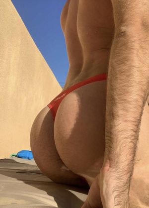 Sexy man in red swim thong