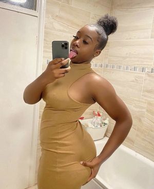 Busty ebony grabs her ass