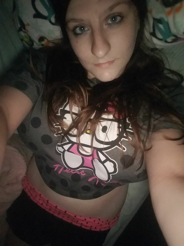 Nerdy Megan taking a selfie while her double D's are out