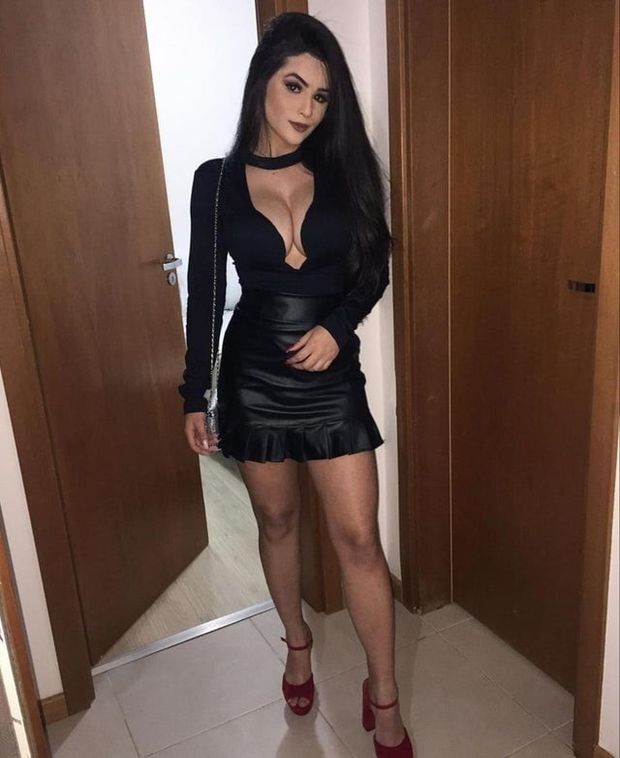 Dark hair beauty posing in sexy black outfit