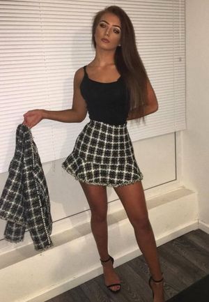 Hot tanned babe in sexy mini skirt and black top