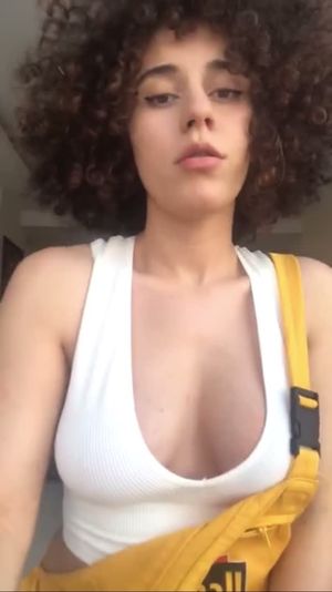 Curly hair teen jump and nude showing her big natural tits.