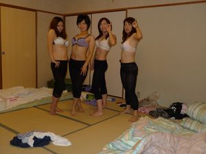Four asians in underwear and pantyhose posing in the bedroom