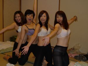 Four asians kneeling in the bedroom in underwear only posing for photo