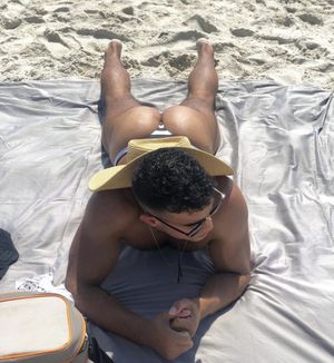 Guy tanning at the beach