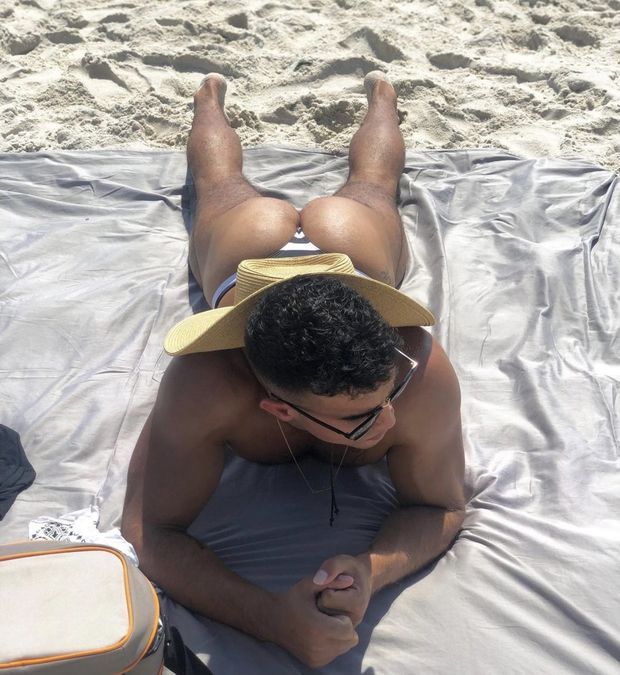 Guy tanning at the beach