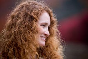 Nice smile to go with her big 36DD tits, tight red haired pussy and very firm ass.