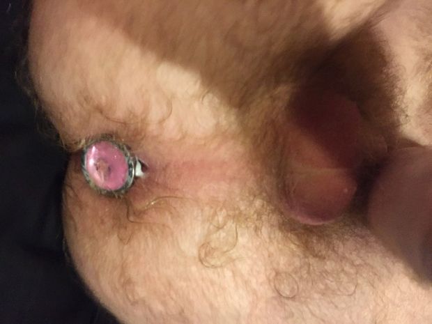 sexy male ass filled with buttplug