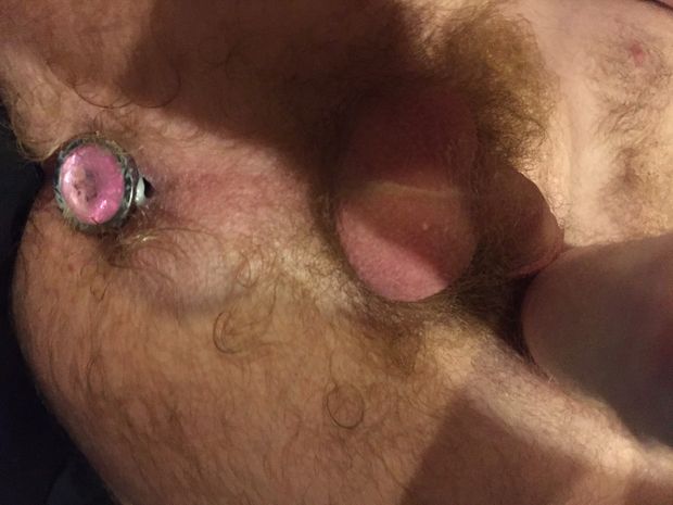 sexy male body featuring a buttplug