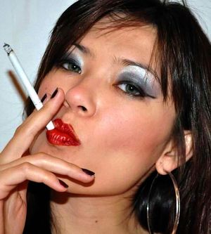 Beautiful bitch taking a long drag from her cigarette