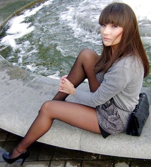 Cute brunette exposing her legs in black nylons