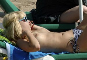 English model Peaches Geldof topless sunbathing