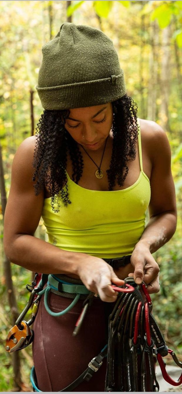 Nipples poke through as she prepares her gear