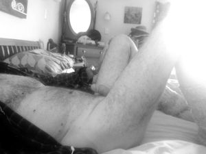 Male on my back, legs open, monochrome