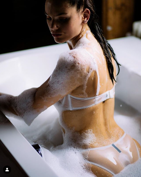 Hot brunette taking a bath