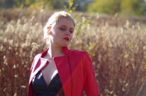 Busty blonde insta model in red leather jacket