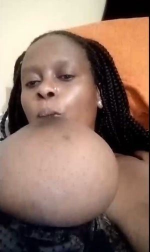 Cam Ebony sucking big tit