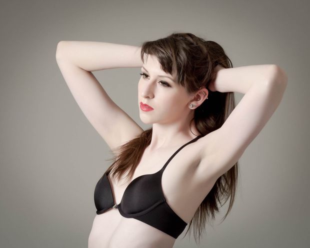 Pale beauty in black bra with small tits and pink lips