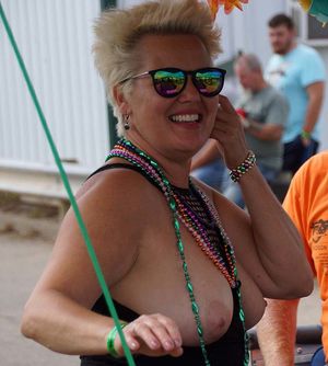 Biker rally woman showing tits for beads