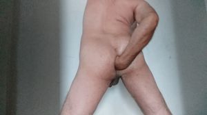 Guy standing up and anally fisting his ass against a wall