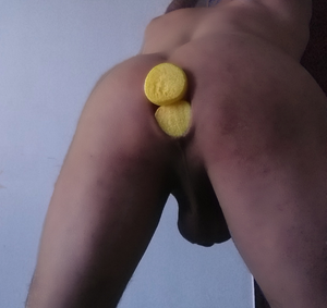 Two big yellow pool noodles inserted in asshole of a guy. Anal dilatation