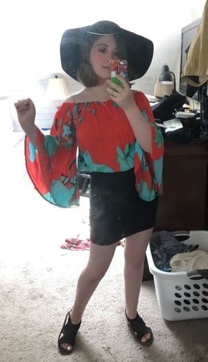 selfie in a red top and black skirt