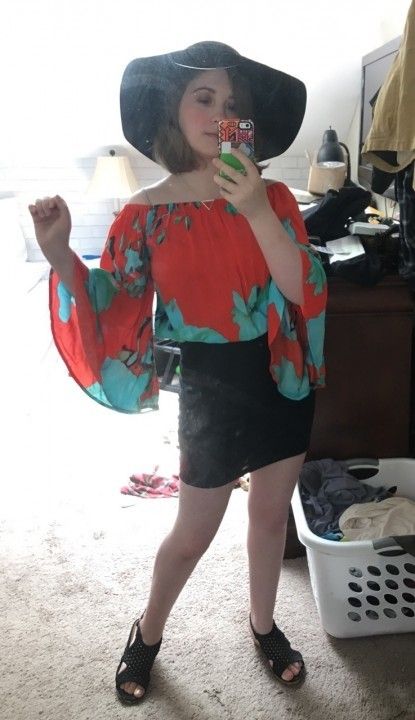 selfie in a red top and black skirt