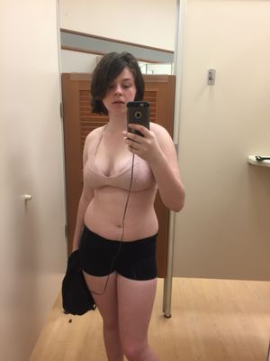 adorable teen showing her curves in the changing room