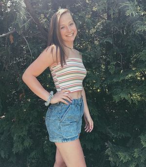 teen posing in striped shirt and jean shorts