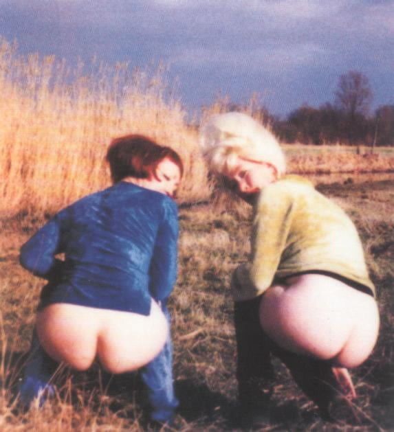 couple of retro gals showing their asses outdoors