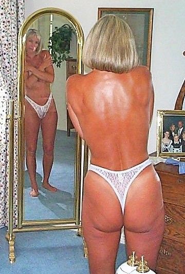Annie poses in front of a mirror that can do special things like sexually enslave her for others.