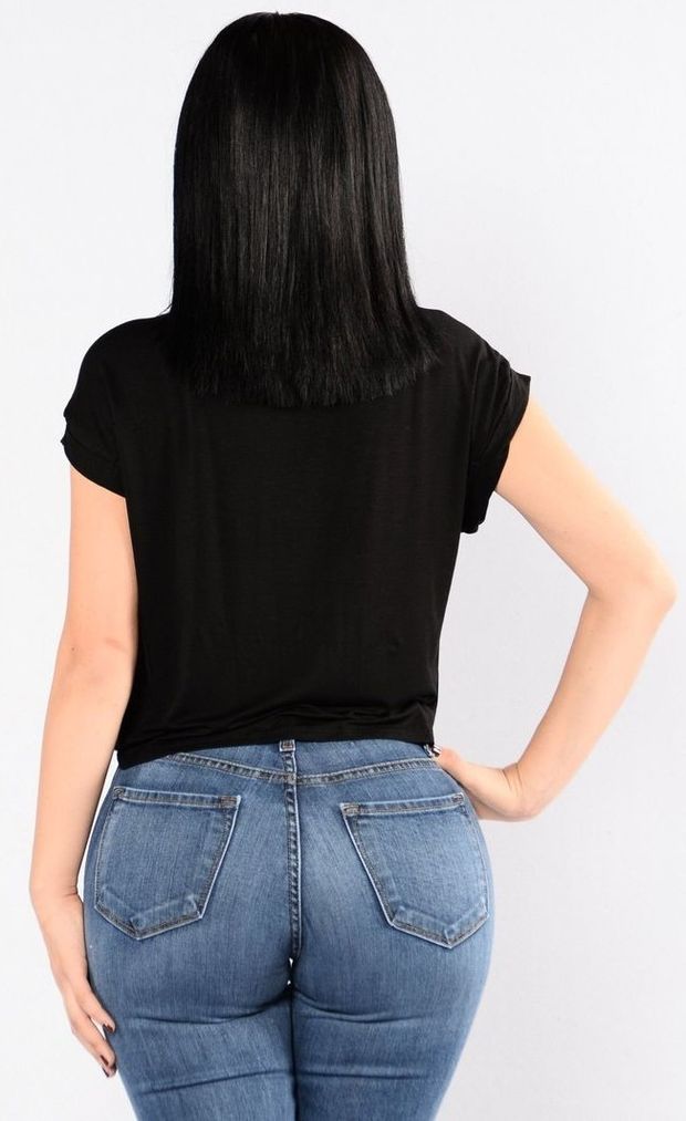 Brunette in light  blue jeans and a black shirt