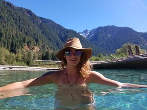 Pretty woman skinny dipping in a beautiful mountain lake