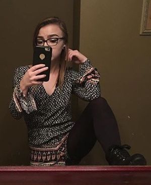 lifting her leg in mirror selfie