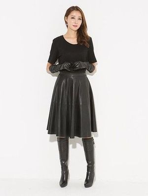 A leather skirt and nice boots makes a woman complete ...